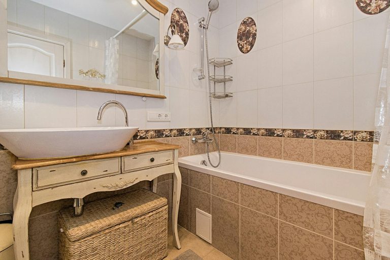 Charming bathroom featuring a vintage sink and bathtub with rustic elegance.